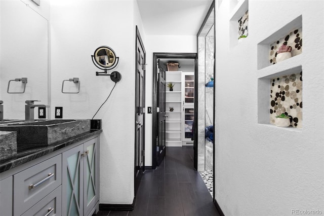 hallway featuring wood tiled floor and a sink