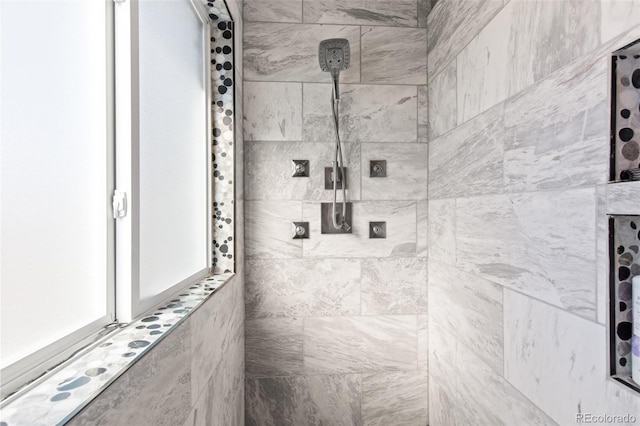 bathroom with a tile shower