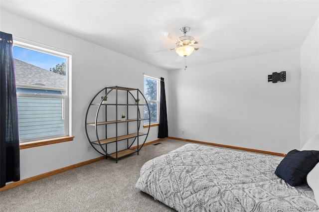 bedroom with light carpet, visible vents, a ceiling fan, and baseboards