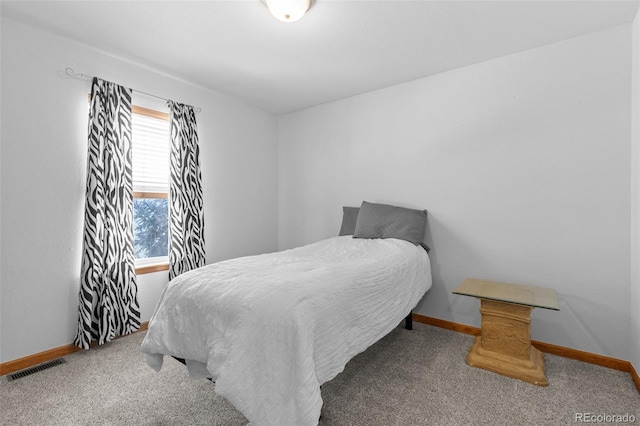 carpeted bedroom with baseboards and visible vents