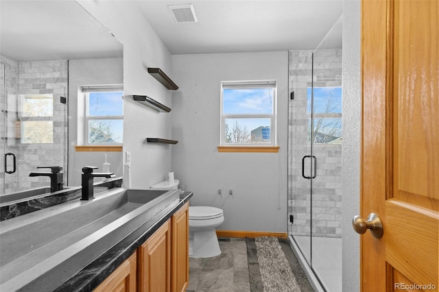 full bathroom with a shower stall, visible vents, a wealth of natural light, and vanity