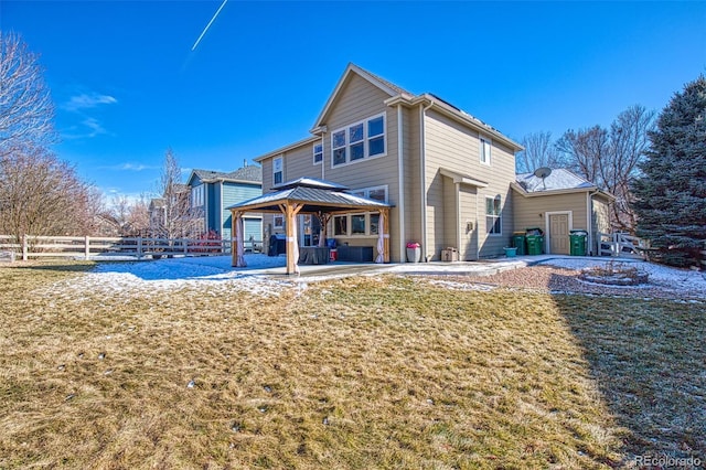 back of property featuring a gazebo, a lawn, a patio, and fence