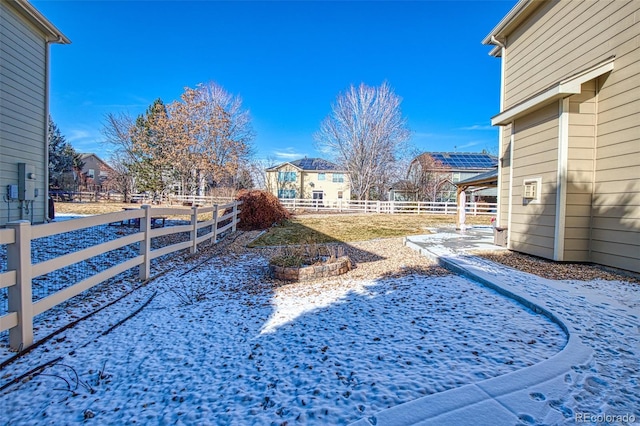 yard covered in snow with a fenced backyard