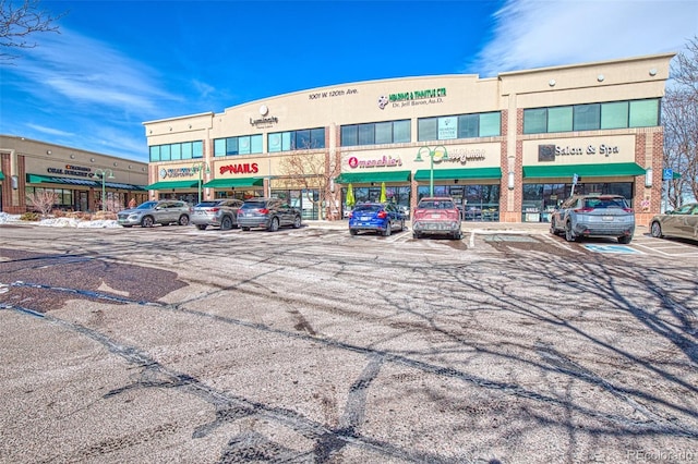 view of building exterior with uncovered parking