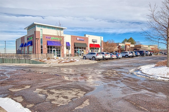 view of building exterior with uncovered parking