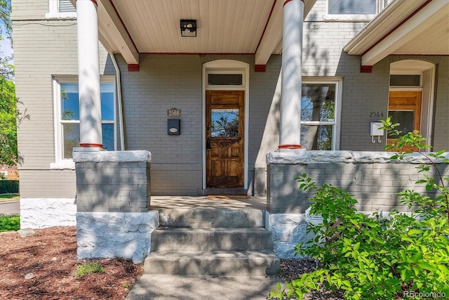 2566 N Emerson St, Denver, CO 80205 - property entrance featuring brick siding and a porch