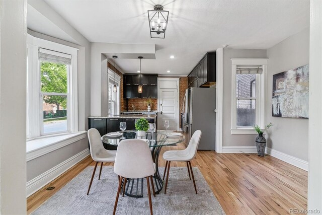 2566 N Emerson St, Denver, CO 80205 - dining room featuring baseboards, light wood finished floors, a chandelier, and recessed lighting