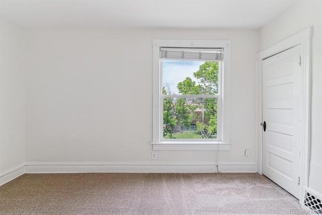 2566 N Emerson St, Denver, CO 80205 - empty room with light colored carpet, healthy amount of natural light, and baseboards