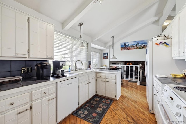 kitchen featuring white appliances, a sink, light wood-style floors, and white cabinets