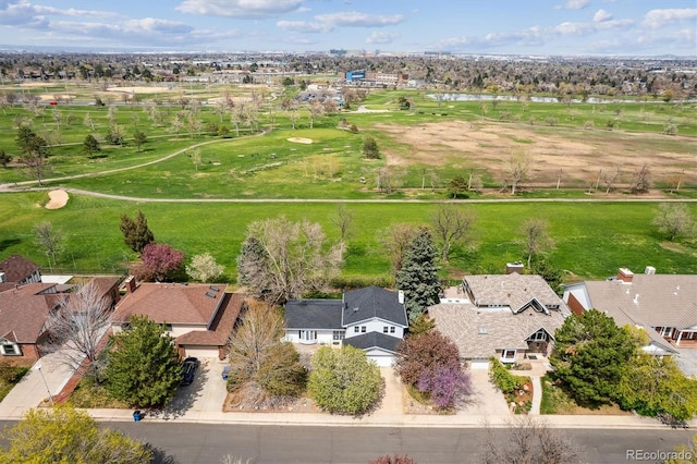 aerial perspective of suburban area featuring a nearby body of water and a golf club