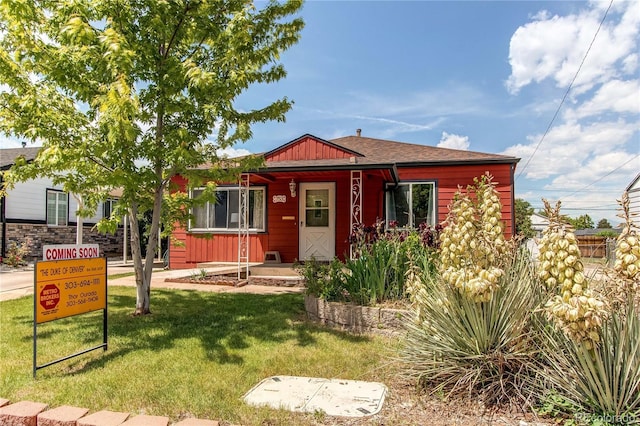 753 S Utica St, Denver, CO 80219 - view of front facade featuring a front lawn and board and batten siding