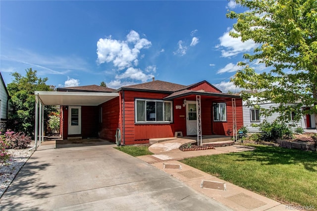 753 S Utica St, Denver, CO 80219 - view of front facade with a front yard, a carport, and concrete driveway