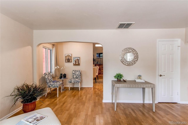 753 S Utica St, Denver, CO 80219 - living room with arched walkways, light wood-type flooring, and baseboards