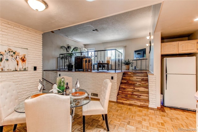 753 S Utica St, Denver, CO 80219 - dining room with brick wall and a textured ceiling