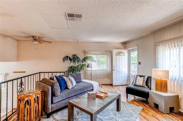 753 S Utica St, Denver, CO 80219 - living room featuring ceiling fan, a textured ceiling, and light wood-type flooring