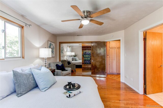 753 S Utica St, Denver, CO 80219 - bedroom featuring light wood-style floors, a closet, and a ceiling fan