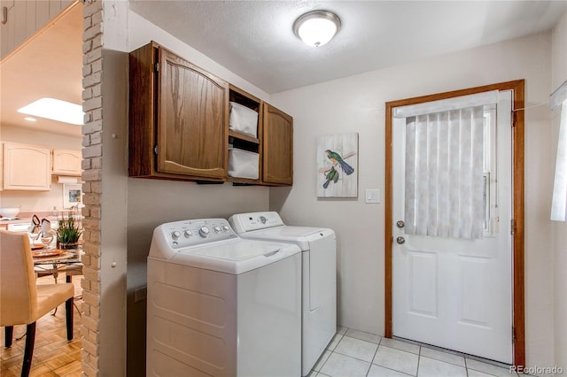 753 S Utica St, Denver, CO 80219 - washroom featuring cabinet space, washer and clothes dryer, and light tile patterned floors