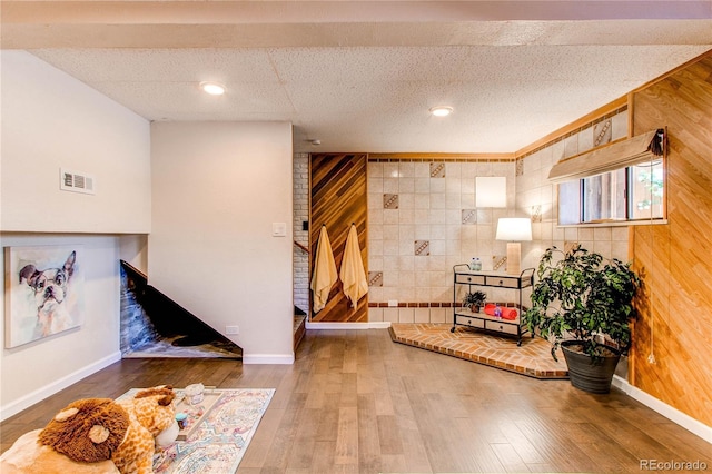 753 S Utica St, Denver, CO 80219 - entryway with hardwood / wood-style floors, baseboards, and wooden walls
