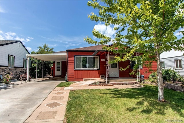 753 S Utica St, Denver, CO 80219 - view of front of property with a front yard, driveway, and a carport