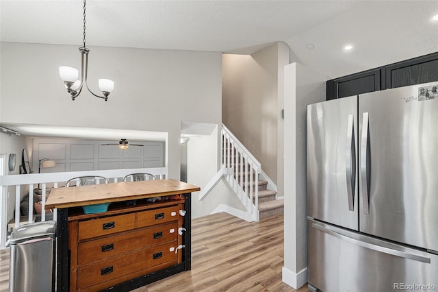 5102 S Lisbon Way, Centennial, CO 80015 - kitchen with freestanding refrigerator, light wood-style floors, decorative light fixtures, ceiling fan, and lofted ceiling