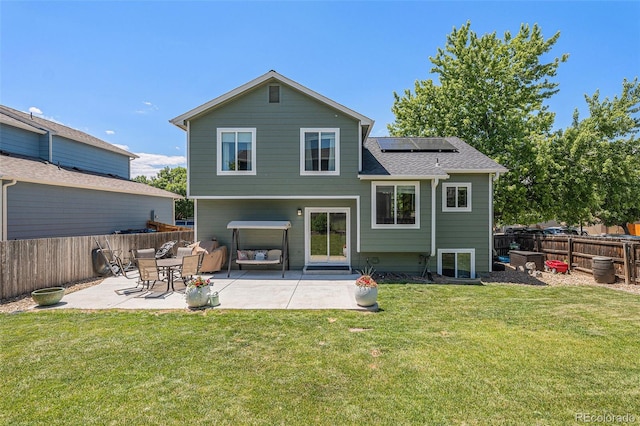 5102 S Lisbon Way, Centennial, CO 80015 - back of house with roof mounted solar panels, a patio, a fenced backyard, and roof with shingles