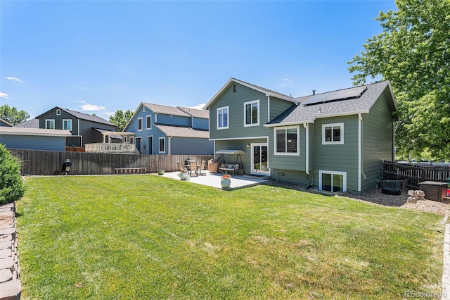 5102 S Lisbon Way, Centennial, CO 80015 - rear view of property with a patio area, solar panels, a fenced backyard, and a shingled roof