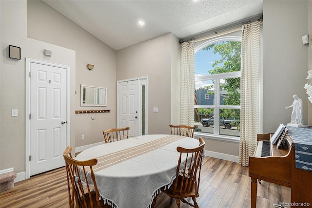 5102 S Lisbon Way, Centennial, CO 80015 - dining area featuring light wood-style flooring, high vaulted ceiling, a textured ceiling, and recessed lighting