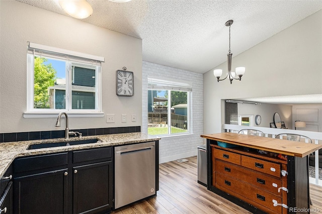 5102 S Lisbon Way, Centennial, CO 80015 - kitchen with dishwasher, dark cabinets, light wood finished floors, a textured ceiling, and a chandelier