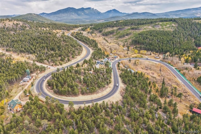24427 Peak To Peak Hwy, Nederland, CO 80466 - aerial overview of property's location featuring a mountain backdrop and a heavily wooded area
