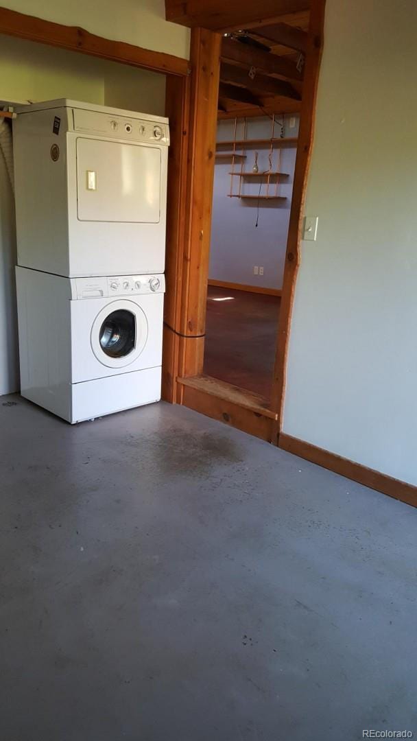 24427 Peak To Peak Hwy, Nederland, CO 80466 - washroom with estacked washer and dryer and baseboards