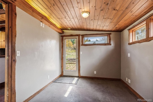 24427 Peak To Peak Hwy, Nederland, CO 80466 - doorway with plenty of natural light, vaulted ceiling, baseboards, wooden ceiling, and unfinished concrete flooring