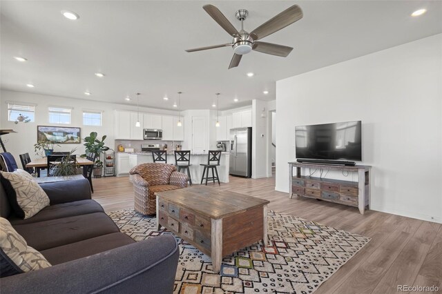 8372 Bijou Creek Ave, Littleton, CO 80125 - living area featuring a ceiling fan, light wood-style flooring, and recessed lighting