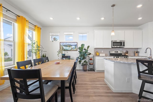8372 Bijou Creek Ave, Littleton, CO 80125 - dining space with recessed lighting, light wood-style floors, and baseboards