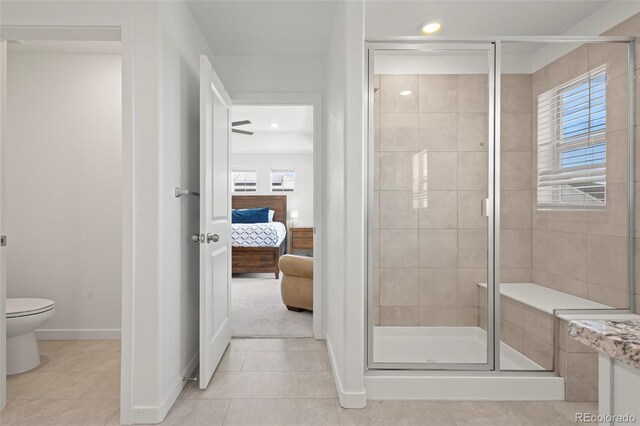 8372 Bijou Creek Ave, Littleton, CO 80125 - ensuite bathroom with a stall shower, tile patterned floors, toilet, recessed lighting, and baseboards