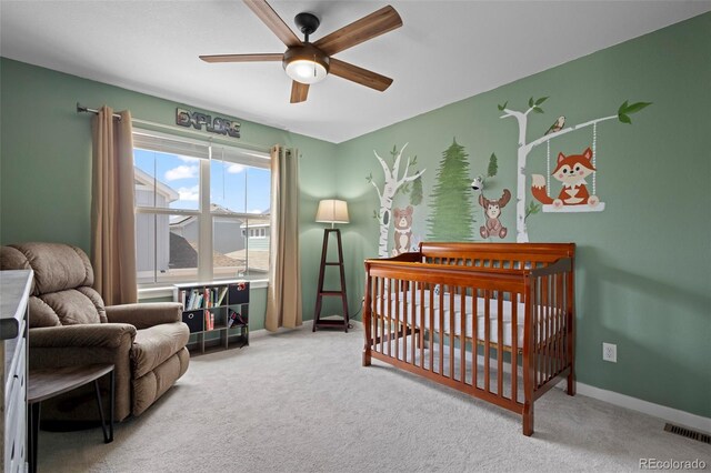 8372 Bijou Creek Ave, Littleton, CO 80125 - carpeted bedroom featuring a crib, baseboards, and ceiling fan