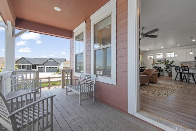8372 Bijou Creek Ave, Littleton, CO 80125 - wooden terrace featuring a porch and a residential view