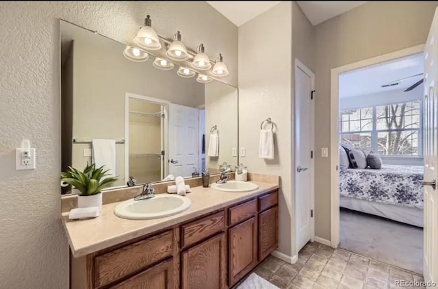 8915 Federal Blvd Unit 203, Westminster, CO 80260 - bathroom featuring double vanity, ensuite bath, a textured wall, and baseboards