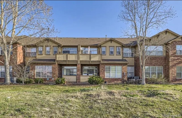 8915 Federal Blvd Unit 203, Westminster, CO 80260 - view of front of property with brick siding, a front lawn, and a balcony