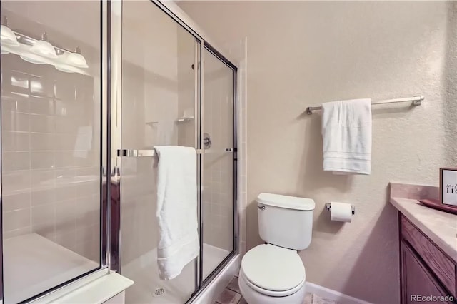 8915 Federal Blvd Unit 203, Westminster, CO 80260 - bathroom with vanity, a shower stall, toilet, and a textured wall