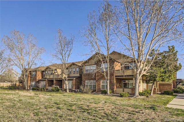 8915 Federal Blvd Unit 203, Westminster, CO 80260 - townhome / multi-family property with brick siding, a front lawn, and a balcony