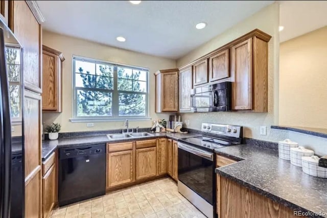 8915 Federal Blvd Unit 203, Westminster, CO 80260 - kitchen featuring black appliances, a sink, dark countertops, recessed lighting, and brown cabinets