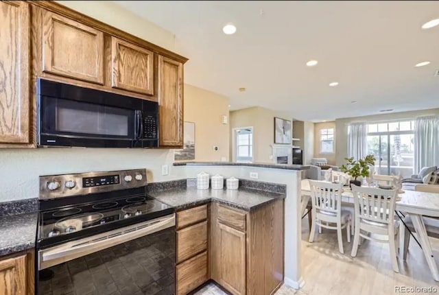 8915 Federal Blvd Unit 203, Westminster, CO 80260 - kitchen featuring black microwave, stainless steel electric stove, a peninsula, open floor plan, and recessed lighting