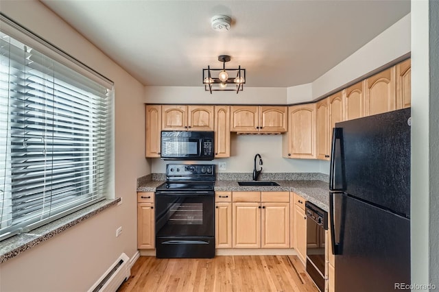 kitchen featuring a sink, black appliances, and light brown cabinets