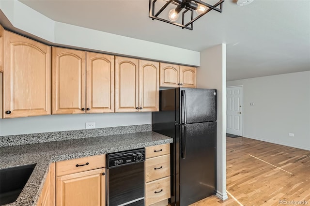 kitchen with black appliances, light brown cabinets, light wood-style floors, baseboards, and a chandelier