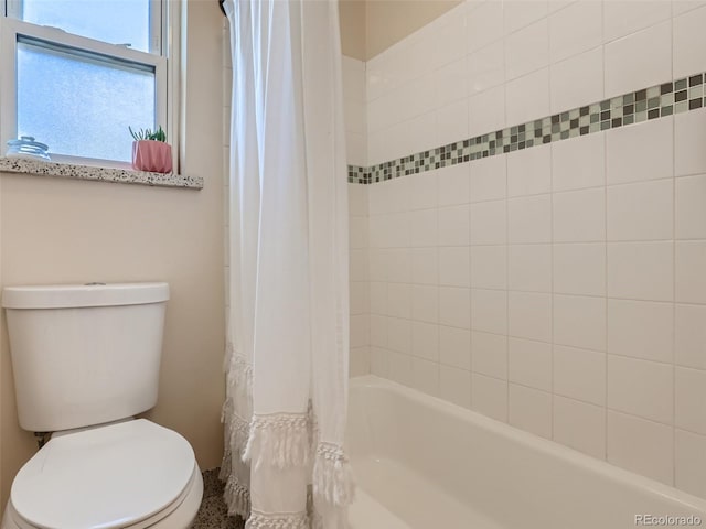 bathroom featuring toilet and shower / bath combo