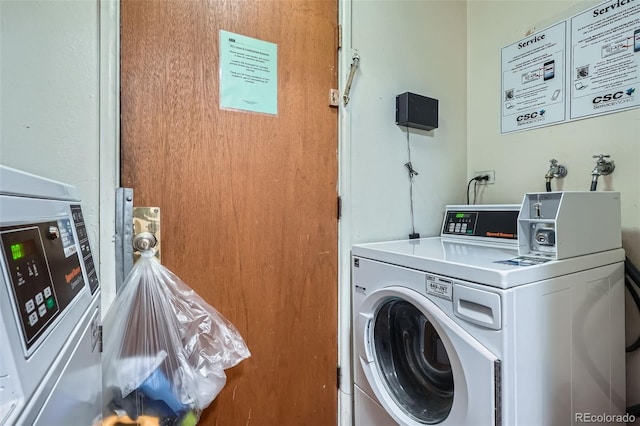 community laundry room featuring washing machine and clothes dryer