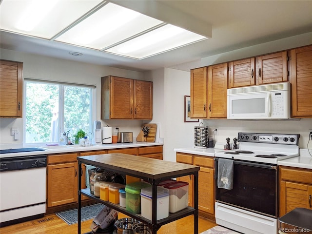 5695 W 109th Cir, Westminster, CO 80020 - kitchen with white appliances, light countertops, and brown cabinets