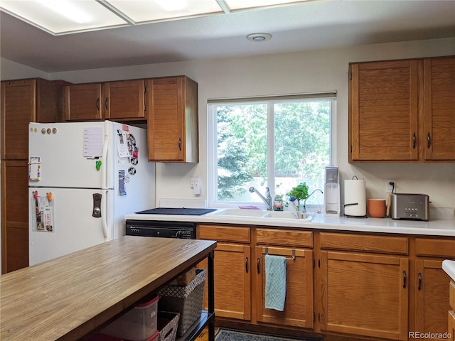 5695 W 109th Cir, Westminster, CO 80020 - kitchen with freestanding refrigerator, brown cabinets, and dishwasher