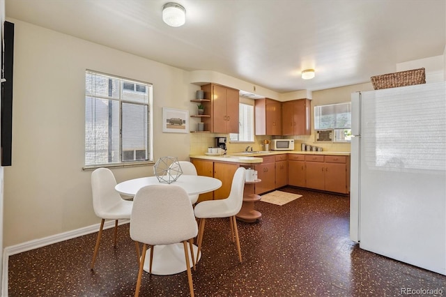2431 S York St, Denver, CO 80210 - kitchen with white appliances, open shelves, light countertops, dark floors, and backsplash