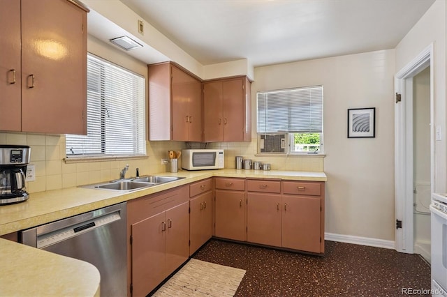 2431 S York St, Denver, CO 80210 - kitchen featuring white microwave, stainless steel dishwasher, light countertops, decorative backsplash, and dark flooring